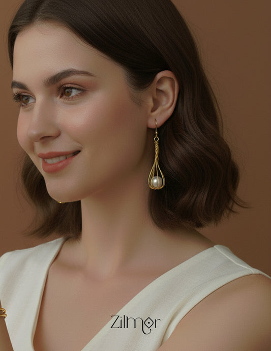 Close-up detail of the intricate golden wire work holding the pearl.