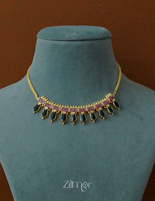 Close-up of the traditional Nagapadam (serpent coil) pendant with ad stone details.