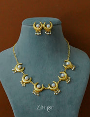 Complete matching jewelry set with pearl and half moon necklace and stud earrings.