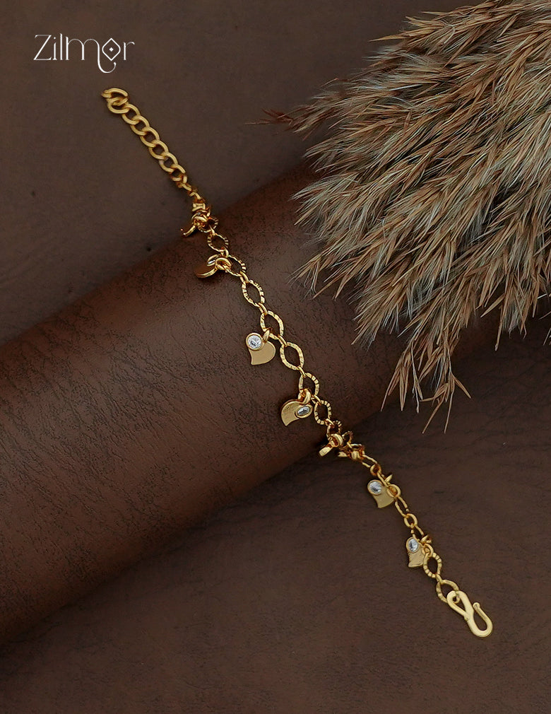 Diagonal view of Zilmor gold plated chain bracelet with dangling heart charms and AD stone accents.