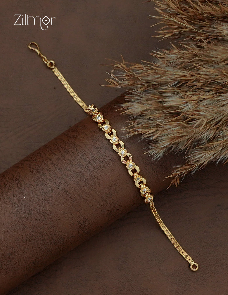 Zilmor 18K gold plated AD stone flower chain bracelet shown diagonally with floral motifs and oval links.