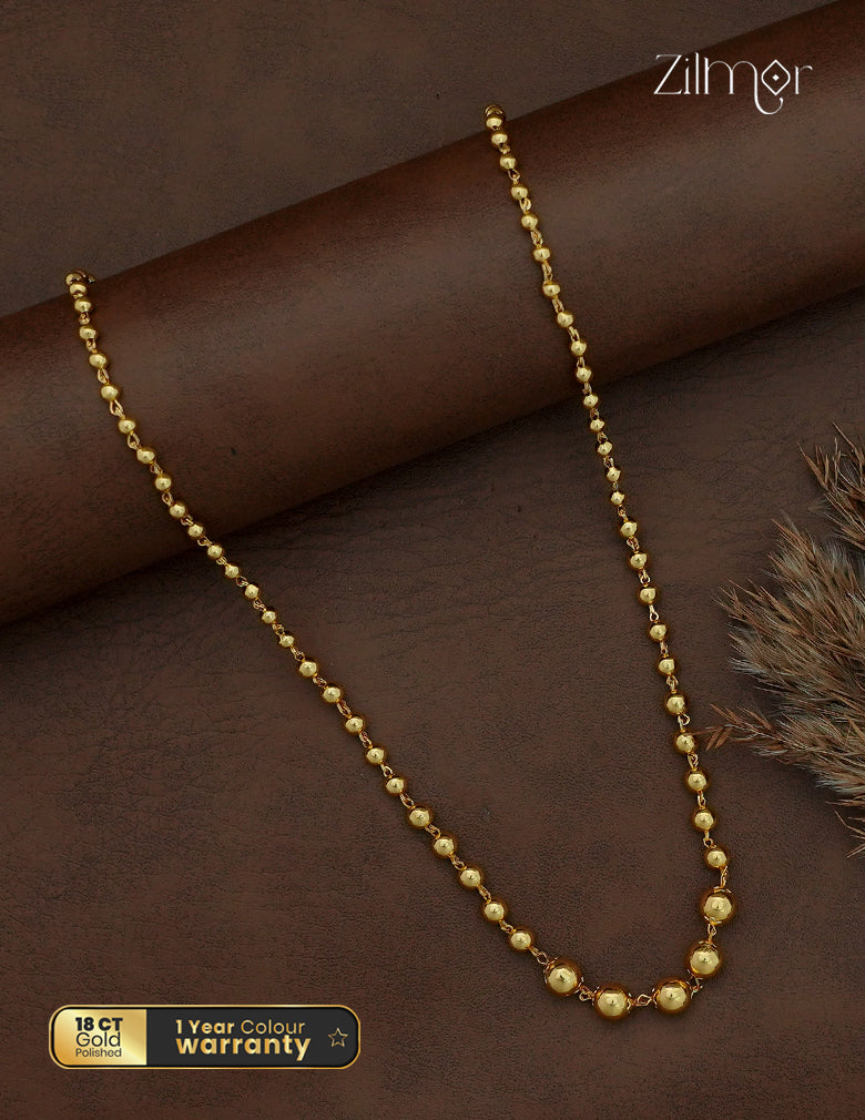 Zilmor gold-toned ball bead mani chain necklace with graduated round centre beads on a brown display