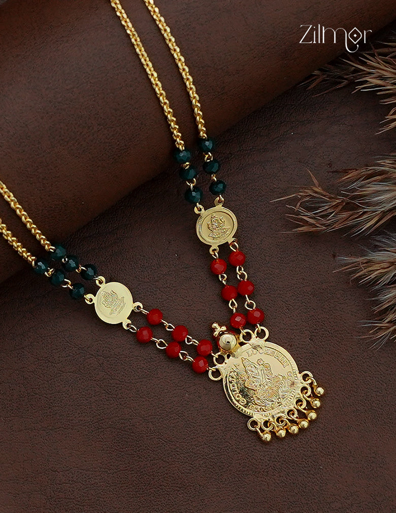 Close-up of 18K gold plated Lakshmi coin long necklace with red and dark green beads