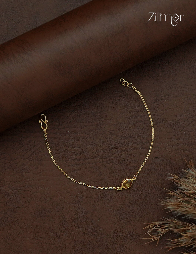 Close-up of oval sky blue stone on Zilmor gold plated chain bracelet