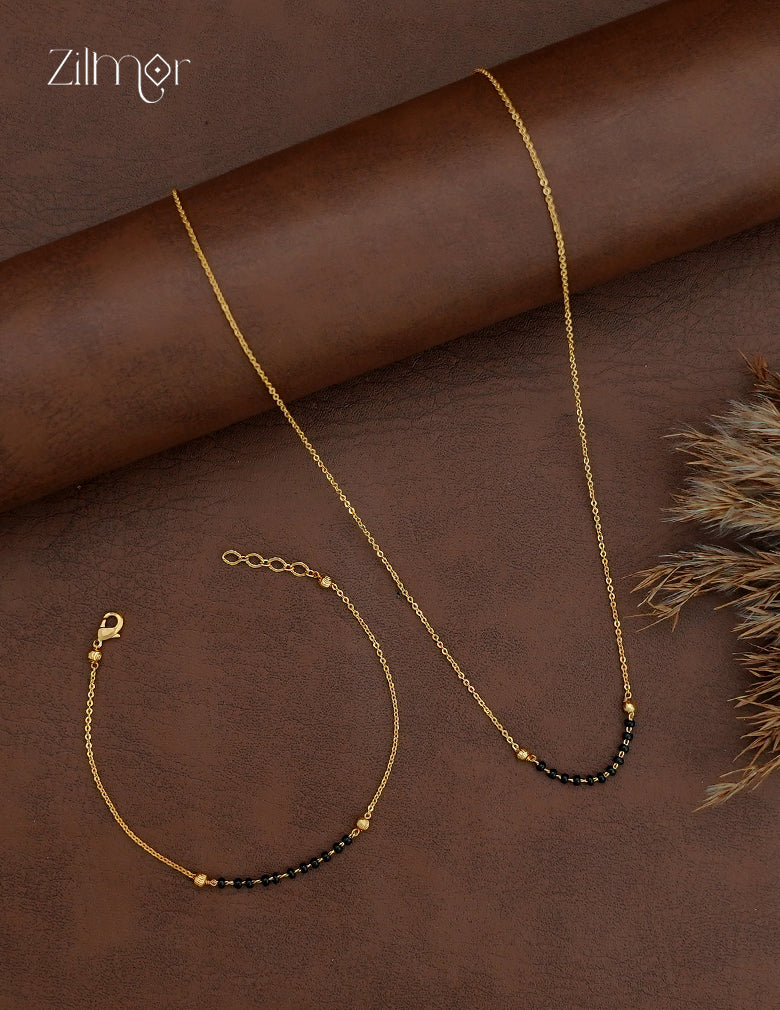 Simple 18K gold plated mangalsutra necklace and matching bracelet with short black bead accents on gold-toned chains