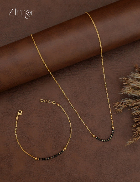 Simple 18K gold plated mangalsutra necklace and matching bracelet with short black bead accents on gold-toned chains