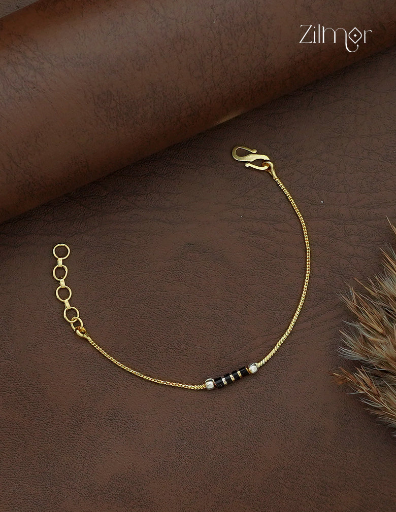 Zilmor gold and white gold plated bracelet with central black beads, slim gold-tone chain and extension links