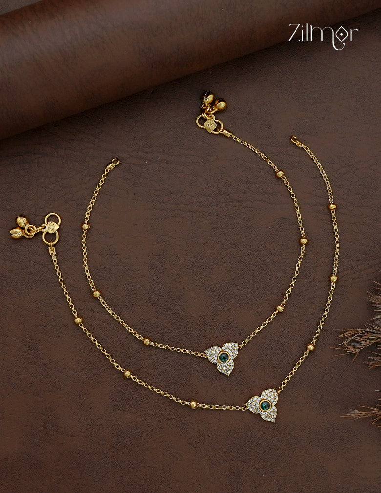 Pair of gold-tone AD stone anklets with three-petal floral motifs, green centres and bead-accent chains