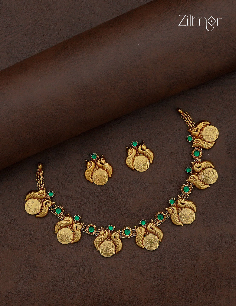 Antique gold Lakshmi coin necklace and earring set with peacock motifs and emerald green stones by Zilmor
