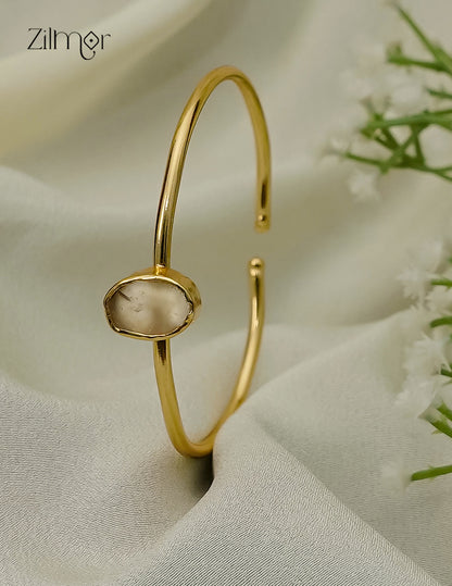 Gold plated adjustable bangle with natural raw stone, cream tone
