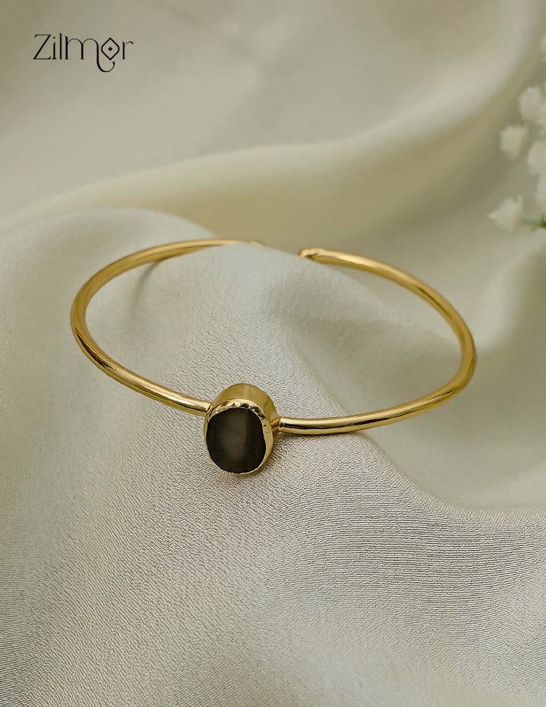 Gold plated adjustable bangle with natural raw stone, close up