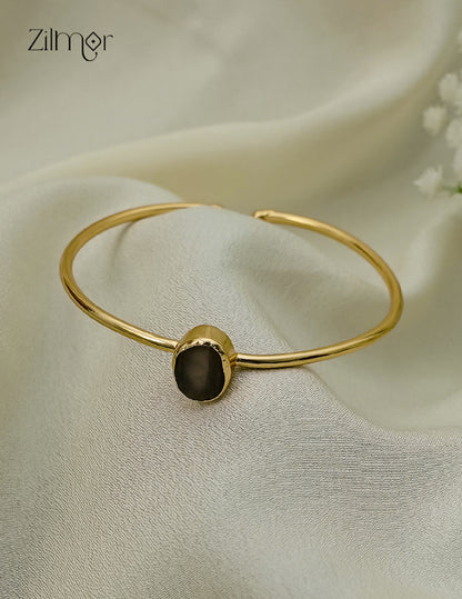 Gold plated adjustable bangle with natural raw stone, close up