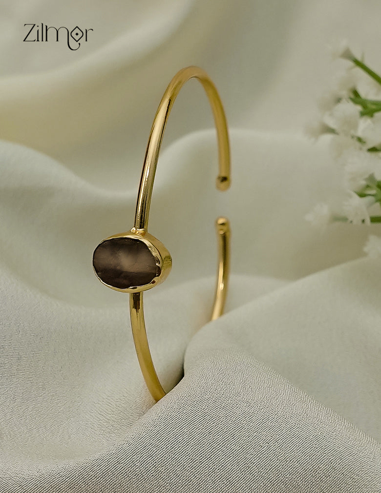 Gold plated adjustable bangle with natural raw stone, front view