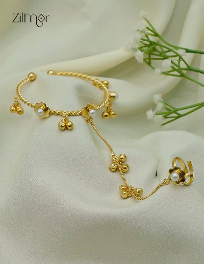 Gold plated adjustable bangle with ring, green stone accent close up