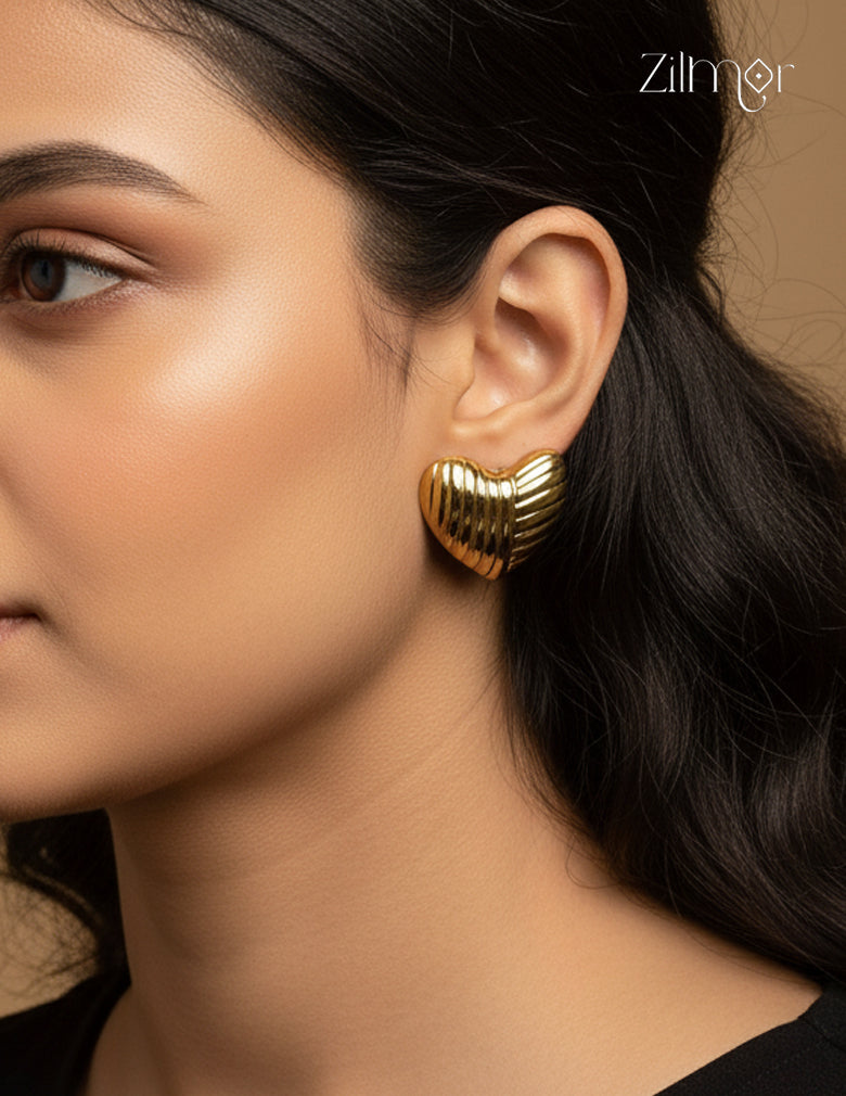 A woman wearing the chic golden heart stud anti-tarnish earrings to showcase their size and style.