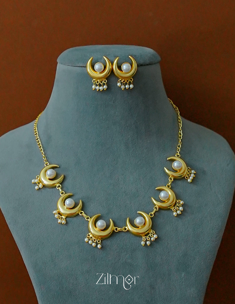 Complete matching jewelry set with pearl and half moon necklace and stud earrings.
